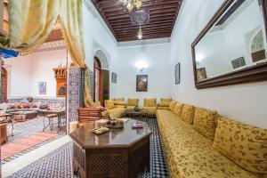 a living room with a couch and a table at Riad L'Artiste in Fez