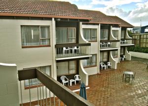 an apartment building with chairs on the balcony at Barcelona Motel in Taupo