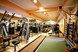 a gym with lots of treadmills and machines at Villa Centrum Młodości in Augustów