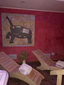 a room with two chairs and a mosaic wall at Hotel Altavilla in Montefiascone
