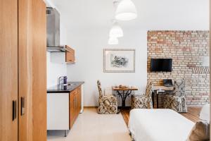a room with a kitchen and a living room at Vilnius Apartments in Vilnius
