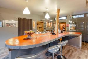 a large kitchen with a large wooden counter top at Lili Paradis in Saint-Savin