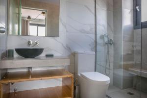 a bathroom with a sink and a toilet and a shower at Villa Lantana in Skala Kefalonias +12 photos
