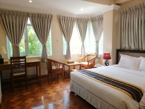 A bed or beds in a room at Grand Laurel Hotel