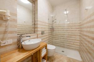 a bathroom with a sink and a toilet and a shower at Vilnius Apartments in Vilnius