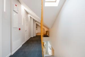 a hallway of a house with white walls and a window at Vilnius Apartments in Vilnius
