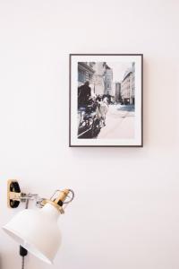 a picture of a man on a bike on a wall at HeyMi Apartments Stephansdom in Vienna