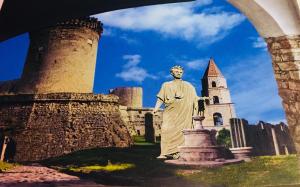 a statue of a man in front of a castle at Gesualdo da Venosa in Venosa