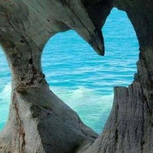 a view of the ocean through a rock formation at Rosy's Apartments in Trappeto