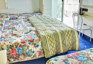 Postel nebo postele na pokoji v ubytování Hotel Tridentum