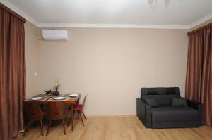 a living room with a table and a couch at SHAKO's Apartments in Tbilisi City