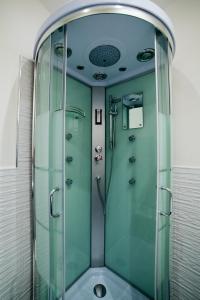 a shower with a glass door in a bathroom at D'HOME FLORENCE in Florence
