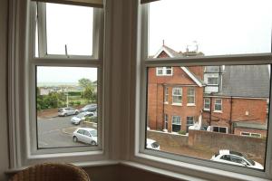 a window with a view of a parking lot at Evee's Pebbles 1 in Eastbourne