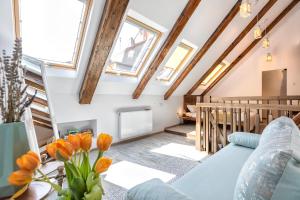 a living room with a blue couch and windows at Casa Carolina Brasov in Braşov