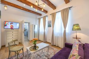 a living room with a purple couch and a table at Casa Carolina Brasov in Braşov