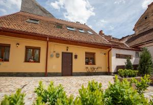 a yellow house with a red roof at Casa Carolina Brasov in Braşov