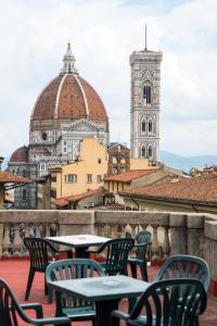 a patio with tables and chairs and a clock tower at D'HOME FLORENCE in Florence +36 photos