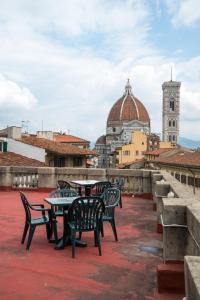 a group of tables and chairs on the roof of a building at D'HOME FLORENCE in Florence