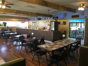 a restaurant with tables and chairs and a bar at Budget Inn Lafonda Motel in Liberal