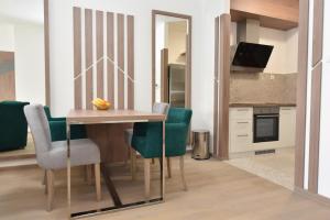 a dining room table and chairs in a kitchen at The Main Square Apartments in Banja Luka