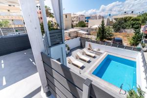 a balcony with a swimming pool on top of a building at Villa Iceberg in Kalamaki Heraklion