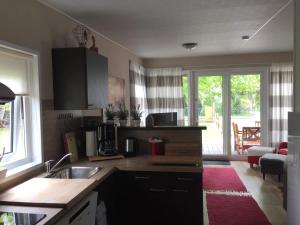 a kitchen with a sink and a counter top at Allgäu-Chalet in Buchloe