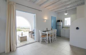 a kitchen and dining room with a table and a window at Magganari Moments 3 in Manganari