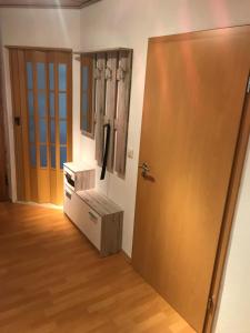 a room with a door and a wooden floor at Gästewohnung Starsiedel in Lützen +3 photos