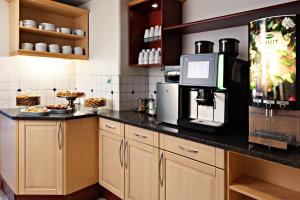 a kitchen with a counter with a coffee maker and a microwave at Center Hotel - Sure Hotel by Best Western in Gothenburg