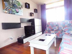 a living room filled with furniture and a tv at Apartsalou Lea in Salou