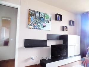 a living room with a painting on the wall at Apartsalou Lea in Salou