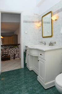 a bathroom with a sink and a mirror at Orestis Suites in Kolios +41 photos