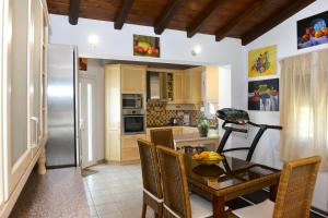 a kitchen with a table and a refrigerator at Orestis Suites in Kolios
