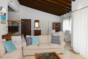 a living room with two white couches and a table at Orestis Suites in Kolios