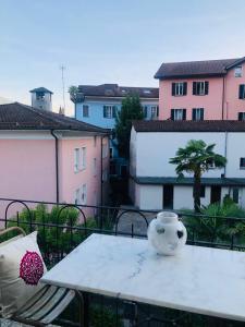 a white vase sitting on a table on a balcony at La Corte dell'Ulivo in Locarno