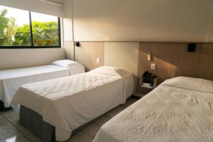Cama ou camas em um quarto em Iguassu Express Hotel