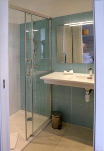 a bathroom with a shower and a sink at Auberge du Cabestan Hotel Audierne in Audierne