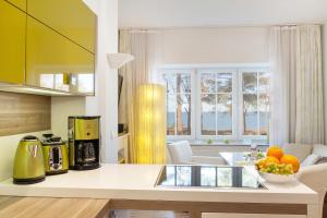 a kitchen with a counter top with a coffee maker at Direkt am Strand mit Meerblick und Sauna - FeWo Strandidyll in Binz