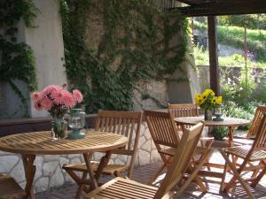 two tables and chairs with flowers on a patio at Dom Góreckich Krakowska 23 in Kazimierz Dolny