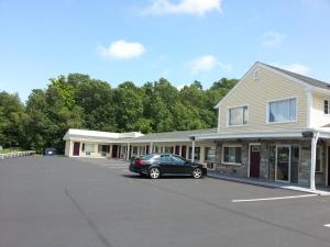 un'auto parcheggiata in un parcheggio di fronte a un edificio di Americas Best Value Inn Providence-North Scituate a North Scituate