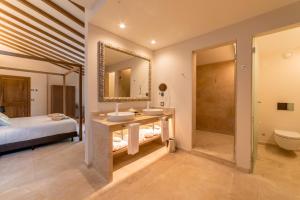
a bathroom with a sink, toilet and bathtub at Hotel Creu de Tau Art&Spa-Adults only in Capdepera
