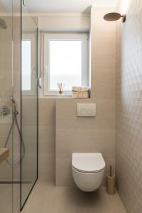 a bathroom with a toilet and a window at Park Residence in Split