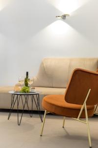 a chair and a table in front of a couch at Park Residence in Split