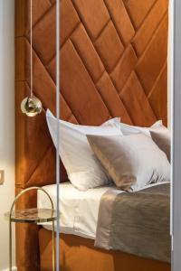 a bed with a wooden headboard and a glass table at Park Residence in Split