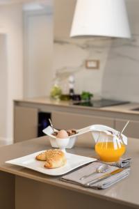 a table with a plate of eggs and a glass of orange juice at Park Residence in Split
