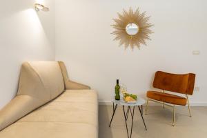a living room with a couch and a chair and a mirror at Park Residence in Split