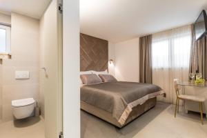 a hotel room with a bed and a bathroom at Park Residence in Split