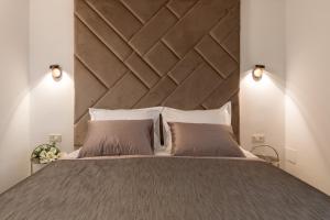 a bedroom with a large bed with a large wooden headboard at Park Residence in Split