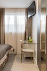 a bedroom with a bed and a desk with a television at Park Residence in Split