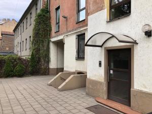 a building with its door open on a street at Family or Group Apartment in Silent Center in Riga